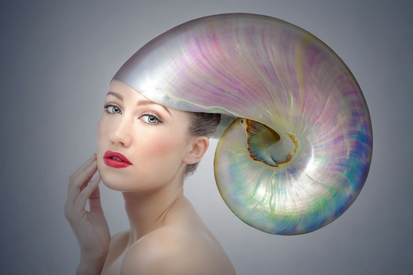 Fashion picture of a lady wearing a shell on her head relating to pearls of wisdom